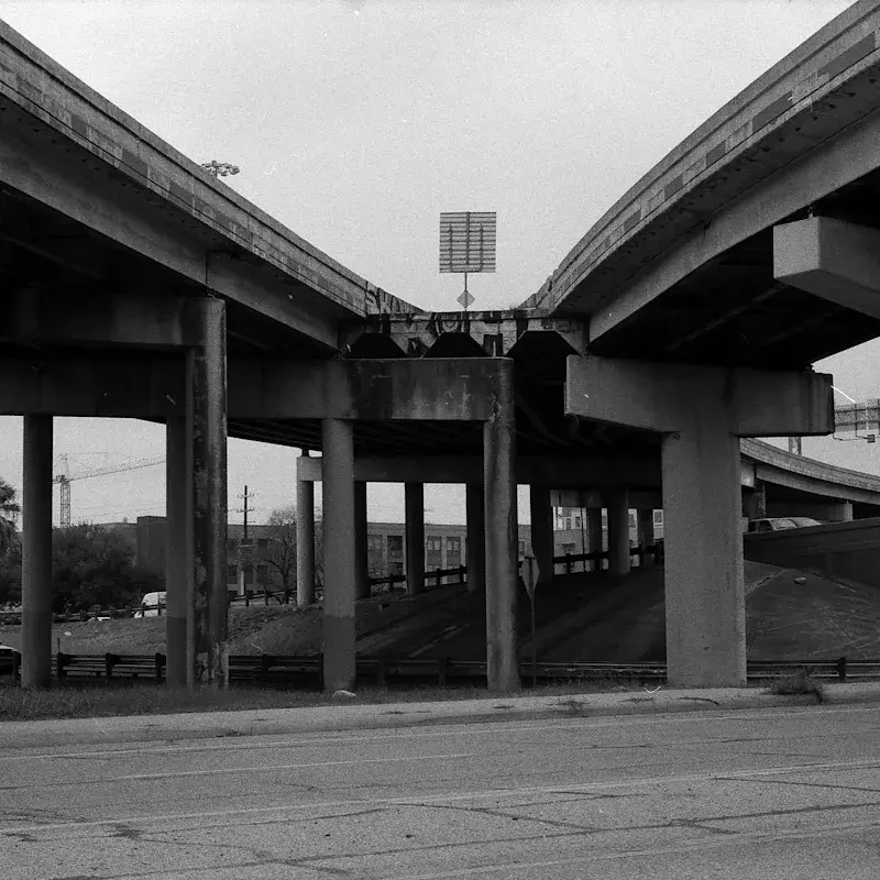 Clean architectural highway structure in dramatic black and white